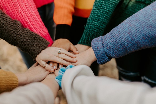 Hands of women in a circle.